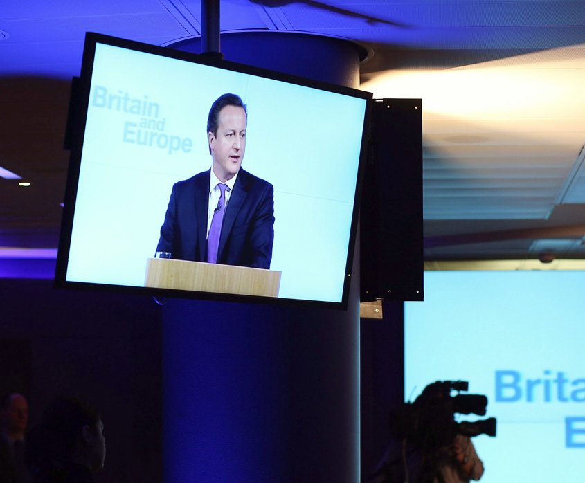 David Cameron appearing on a screen during a speech on Europe