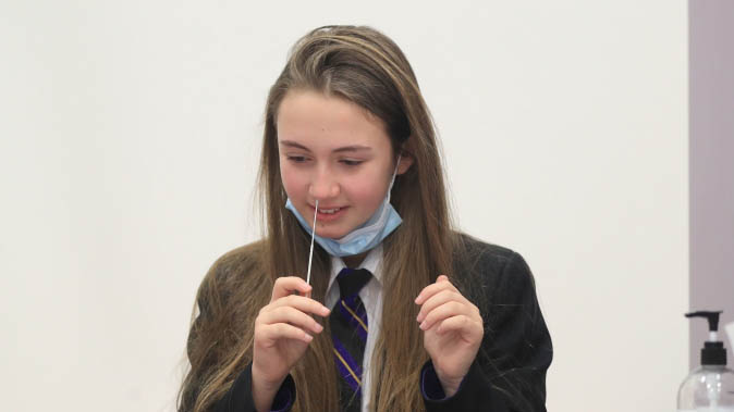 A school pupil takes a lateral flow test