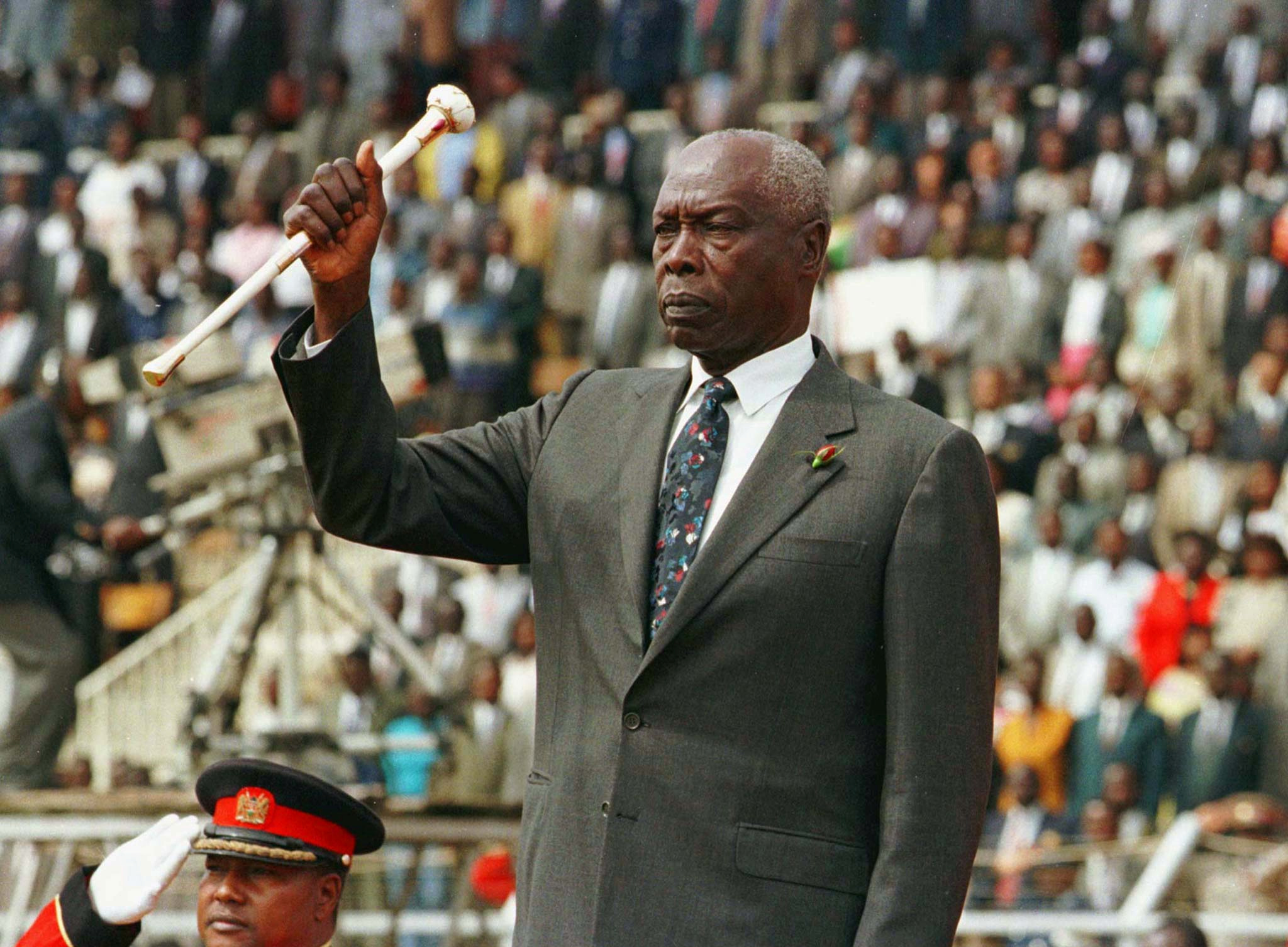 President Daniel Arap Moi raises his baton to salute Kenyans during the 34th independence day celebrations in Nairobi, 