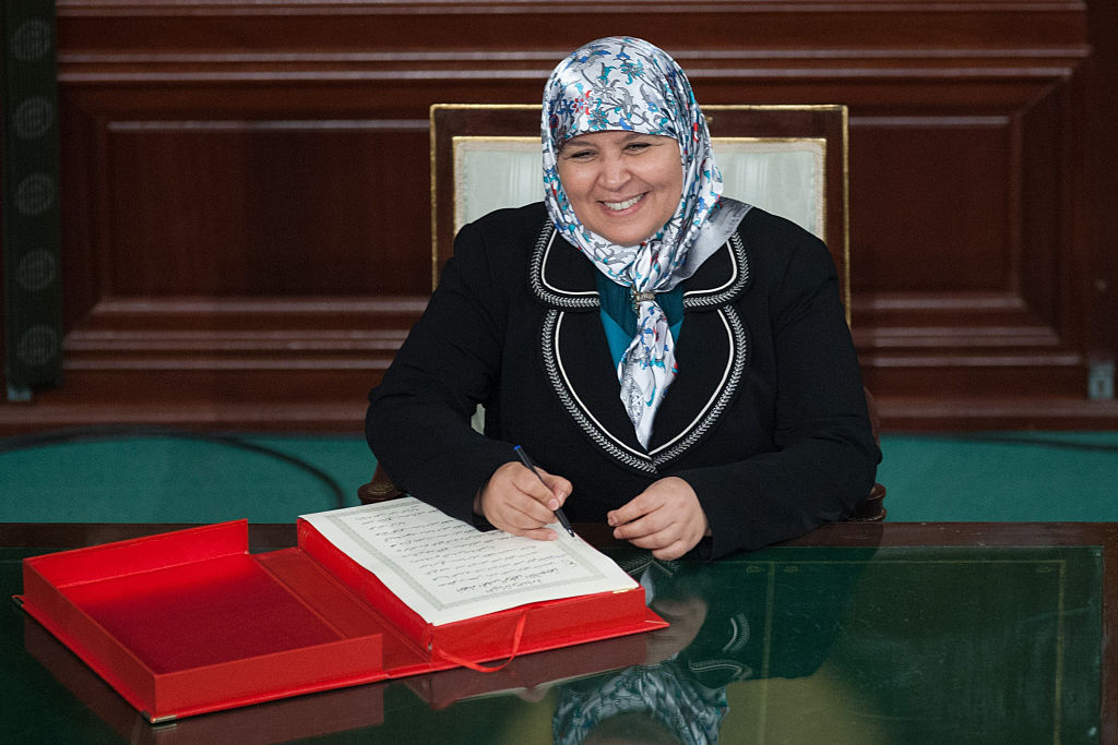 Female politician signing a document