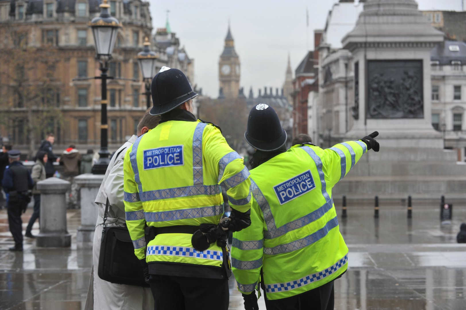 File image of two police officers giving a man directions in Trafalgar Square