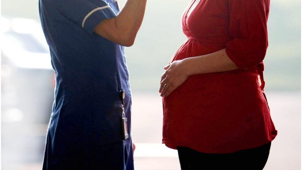 Pregnant woman and nurse