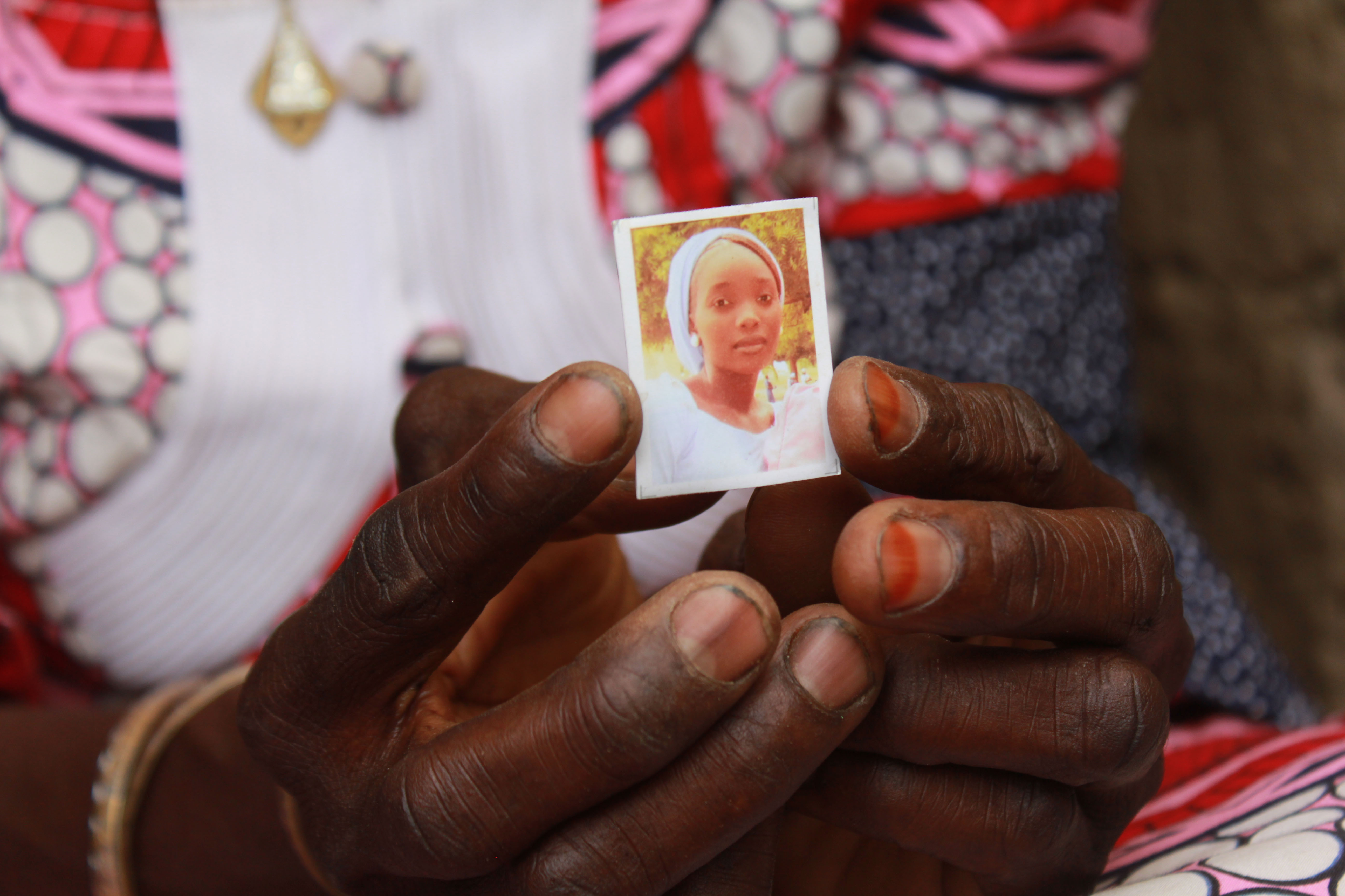 Zainabu Mala, mother of Kabu, one of the abducted girls, holds a picture of her daughter on April 12, 2019 in Chibok