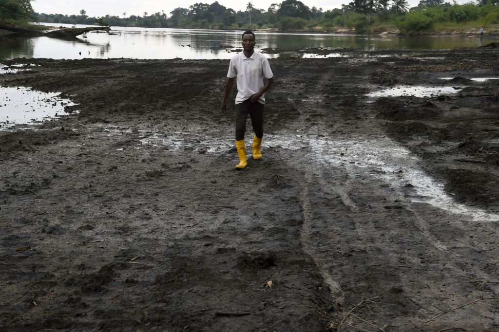 Farmer standing in oil spill area in the Niger Delta