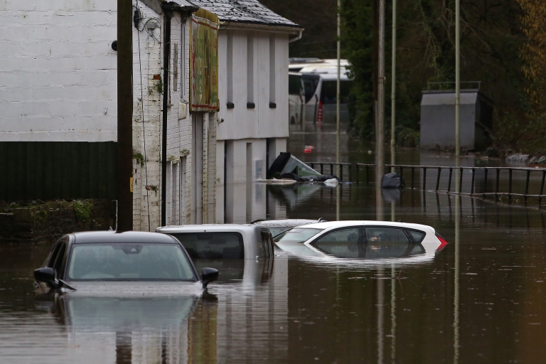 Cars sit submerged in flood water after the River Taff burst its banks in Nantgarw, south of Ponypridd in south Wales on February 16, 2020