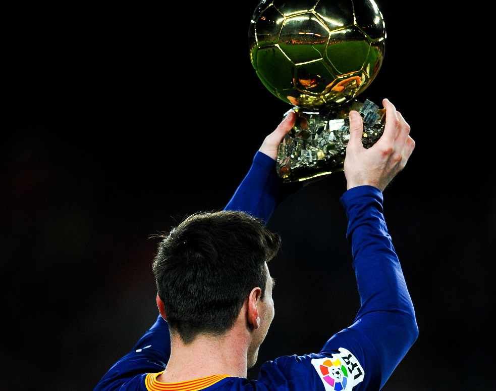 Lionel Messi with the Ballon d'Or