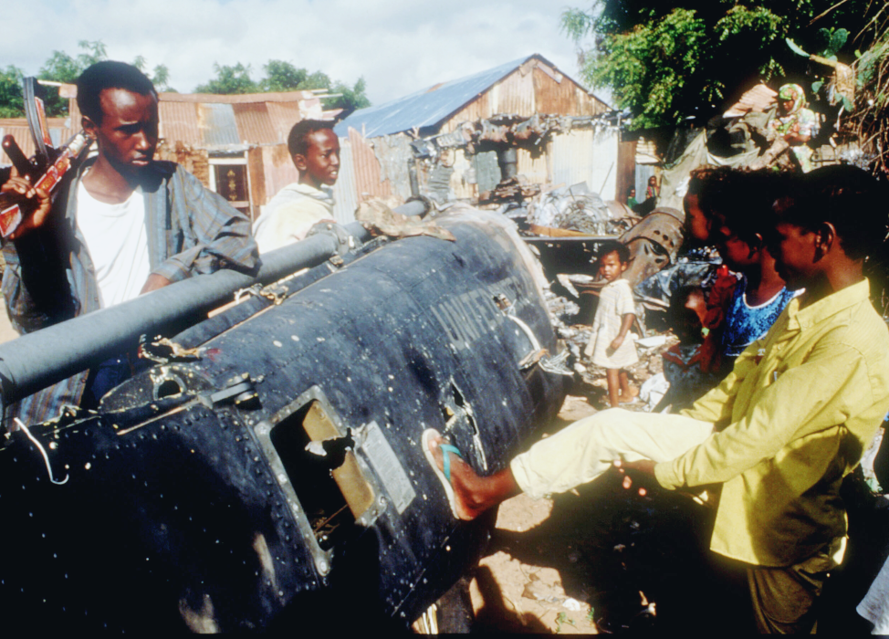 Children play with the wreckage of a US Black Hawk helicopter in Mogadishu, Somalia in December 1993