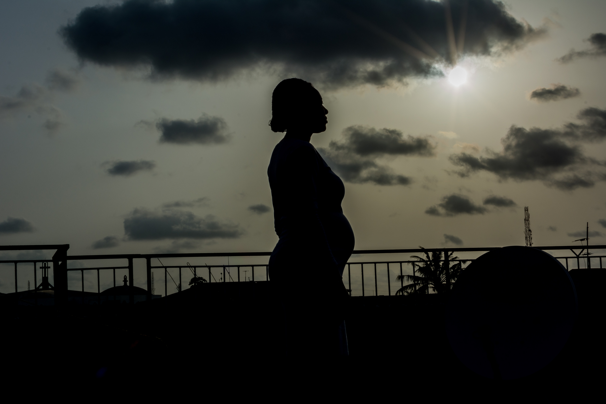 A silhouette of a pregnant woman