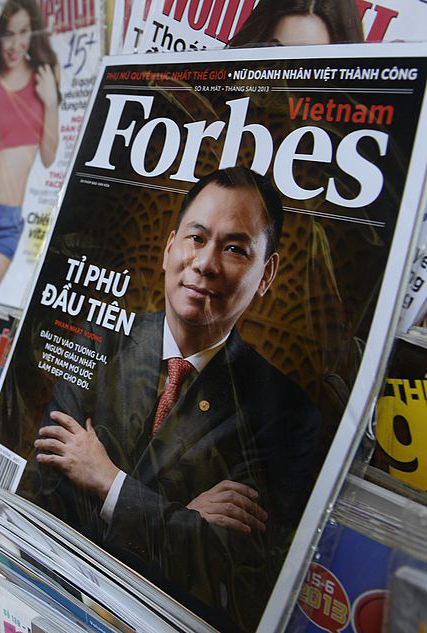 A copy of the newly launched Vietnamese version of Forbes Magazine is seen on sale at a roadside newsstand in Hanoi with VinFast founder in the cover