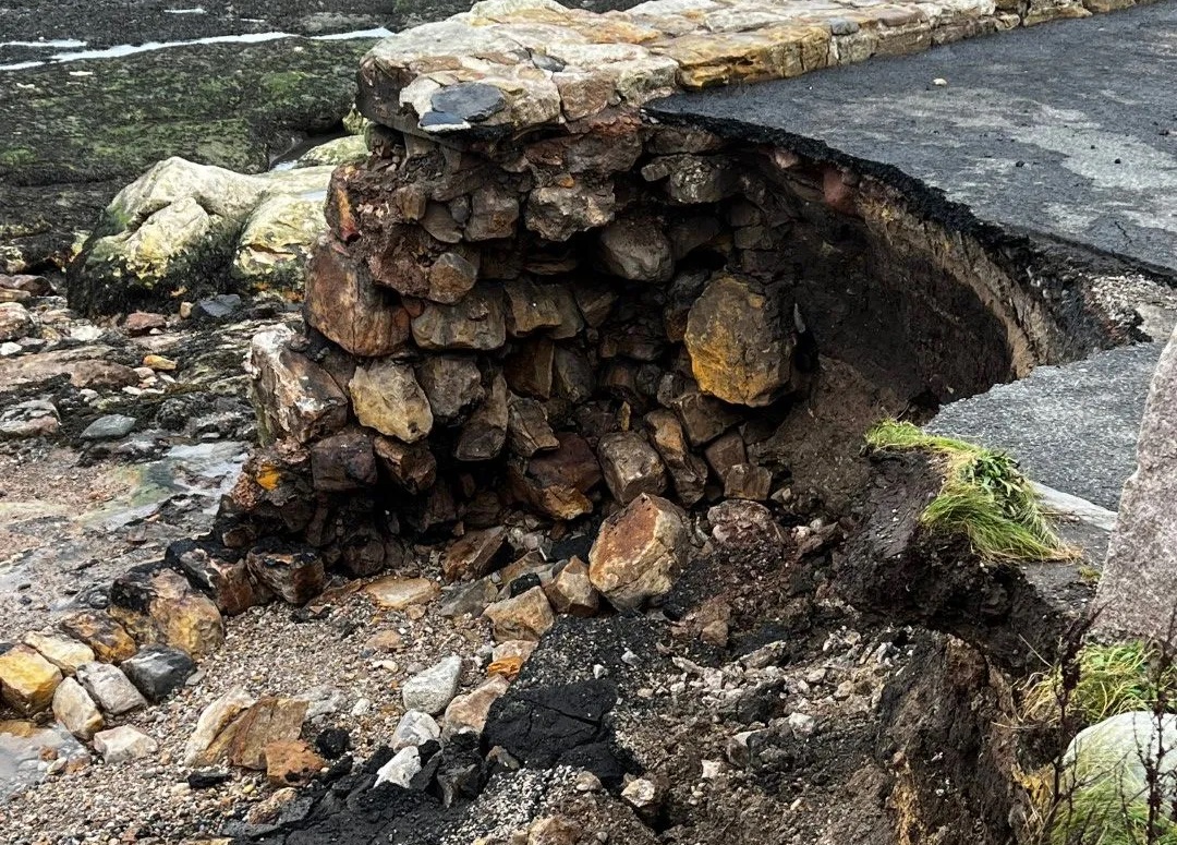 Rocks and debris around a broken section of pier. 