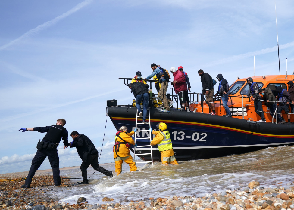 Migrants helped off a lifeboat by RNLI crew and UK Immigration Enforcement officers in Kent - 2021