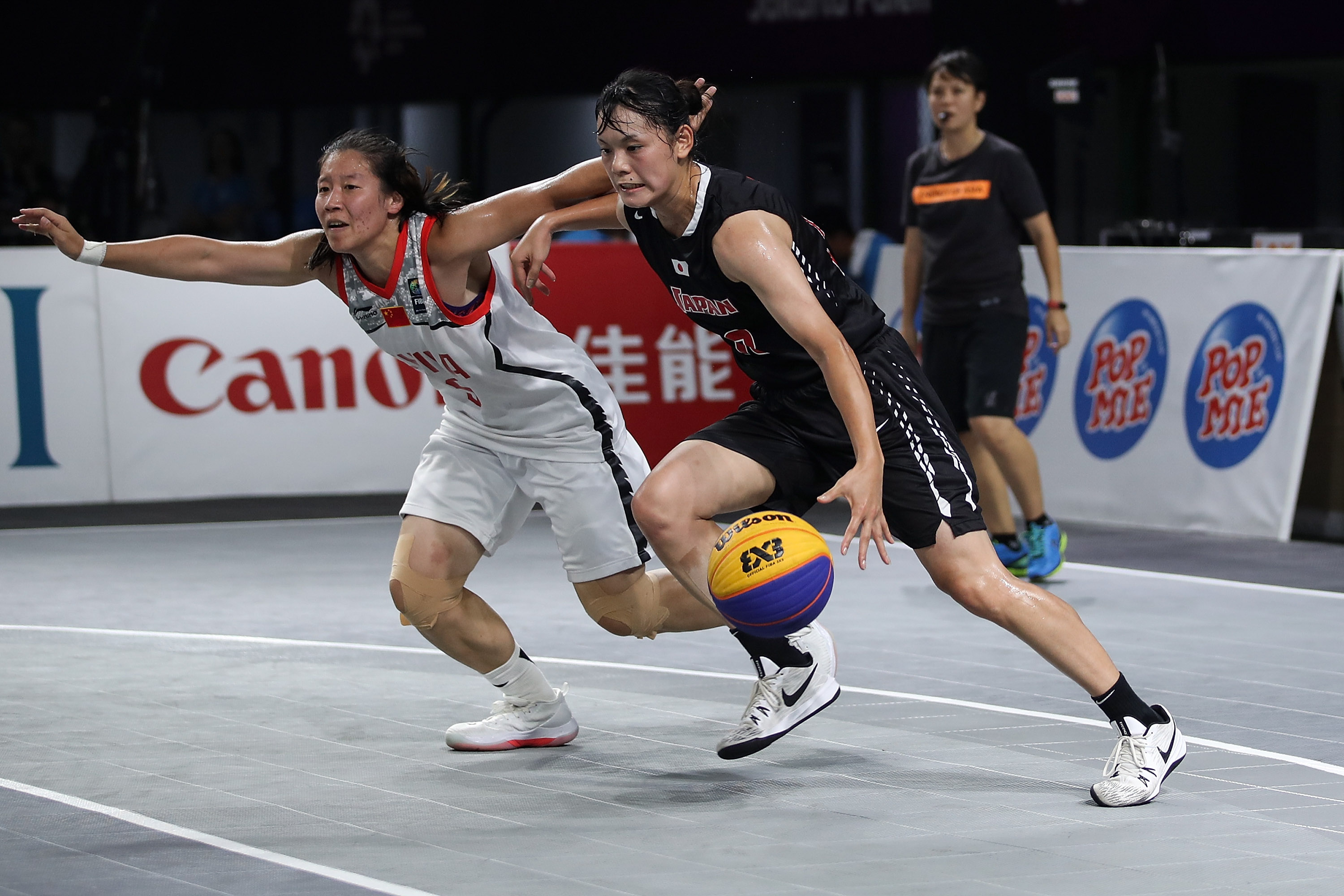 Li Yingyun of China and Okuyama Ririka of Japan in action during Women's Basketball 3X3 Final between China and Japan at the Asian Games on August 26, 2018 in Jakarta, Indonesia.