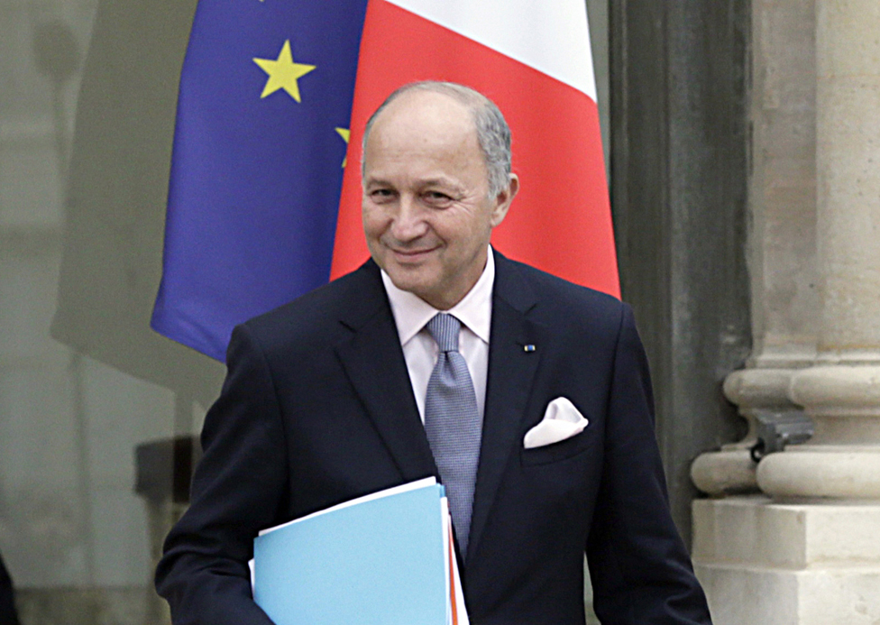 Then-French foreign minister Laurent Fabius holding some folders