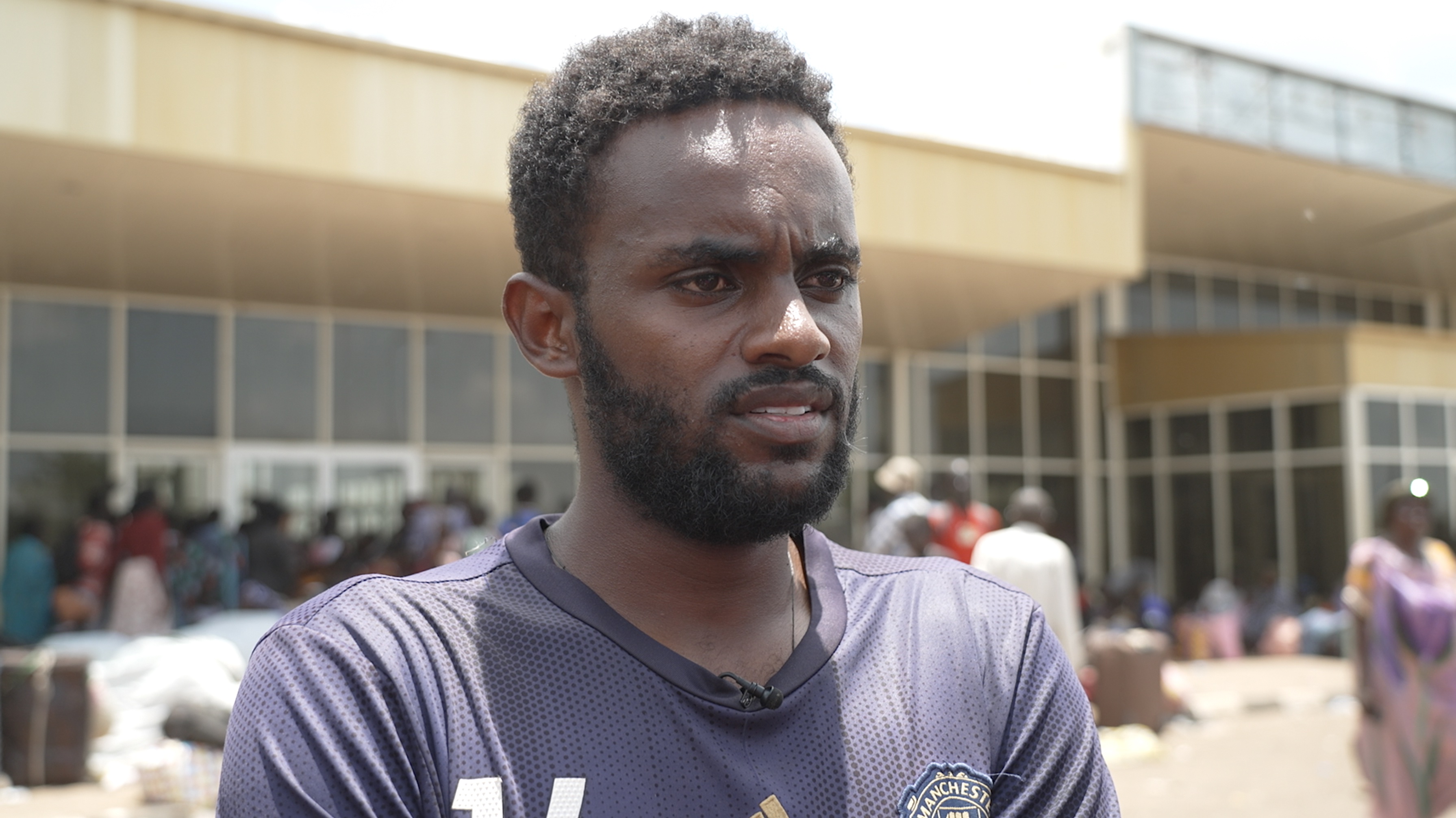 Eritrean man Tesfit Girmay stands in front of the terminal building at Paloich airport in South Sudan