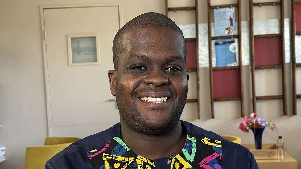 A head shot of Vukosi Marivathe. He has short hair and is smiling.